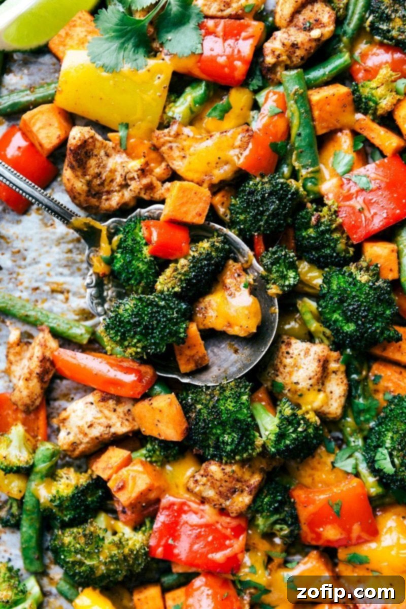 Close-up of perfectly roasted one-pan chicken and veggies, showcasing crispy edges and vibrant colors. Ideal for meal prepping healthy dinners.