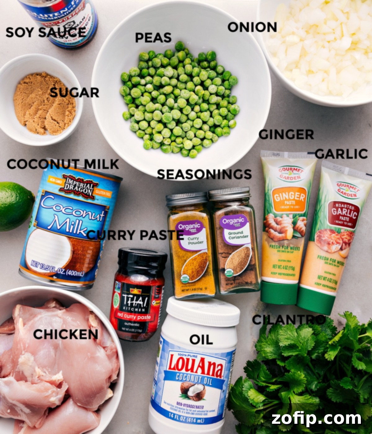 Ingredients In Crockpot Curry Chicken All the ingredients are prepped for easy assembly—peas, onion, garlic, ginger, seasonings, soy sauce, sugar, coconut milk, red curry paste, meat, oil, and cilantro.