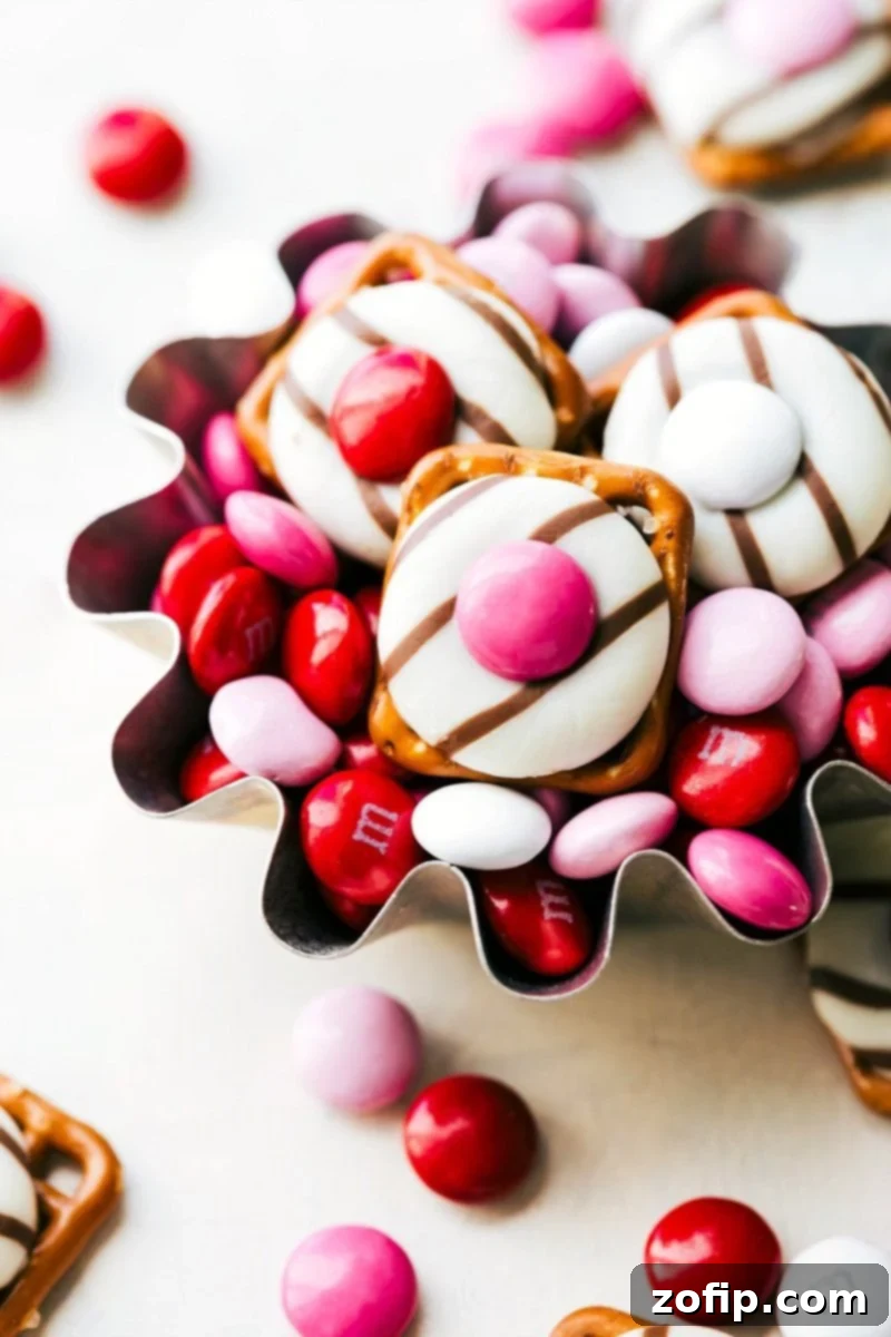 A collection of easy homemade Valentine's Day treats, showcasing Heart Hug Pretzels, Love Fortune Cookies, Mini Valentine Bear, and White Chocolate Heart Pretzels.