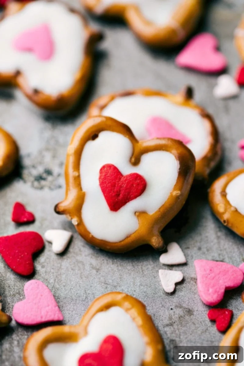 White Chocolate Heart Pretzels elegantly decorated with vibrant jumbo heart sprinkles, perfect for Valentine's Day.