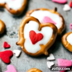 White chocolate filled pretzels topped with a charming red heart sprinkle for Valentine's Day.