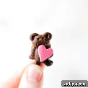 Cute Mini Valentine's Bear made with Teddy Grahams holding a heart sprinkle.