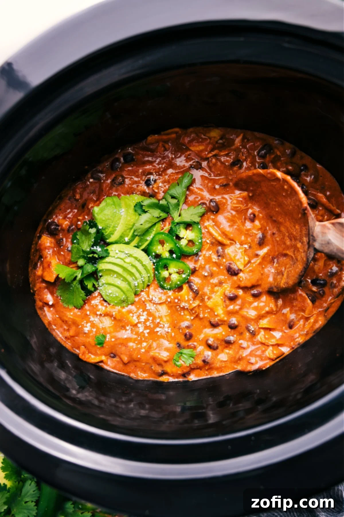 Delicious Crockpot Chicken Enchilada Casserole bubbling hot in the slow cooker, ready to be served.
