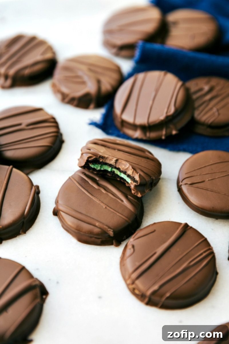 Delicious homemade Thin Mint cookies, alongside a collection of DIY Girl Scout cookie copycat recipes including S'mores Sandwich Cookies, Samoas, and Tagalongs, all made with 4 ingredients or less.