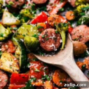 Sheet Pan Italian Sausage and Roasted Vegetables 3 A spoonful of the finished meal, showcasing a bite full of flavor and texture, ready to be enjoyed.