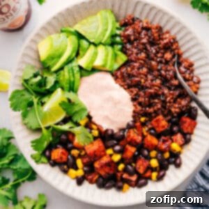 A beautifully assembled Ground Beef Taco Bowl, with vibrant ingredients and sauce, ready for enjoyment.