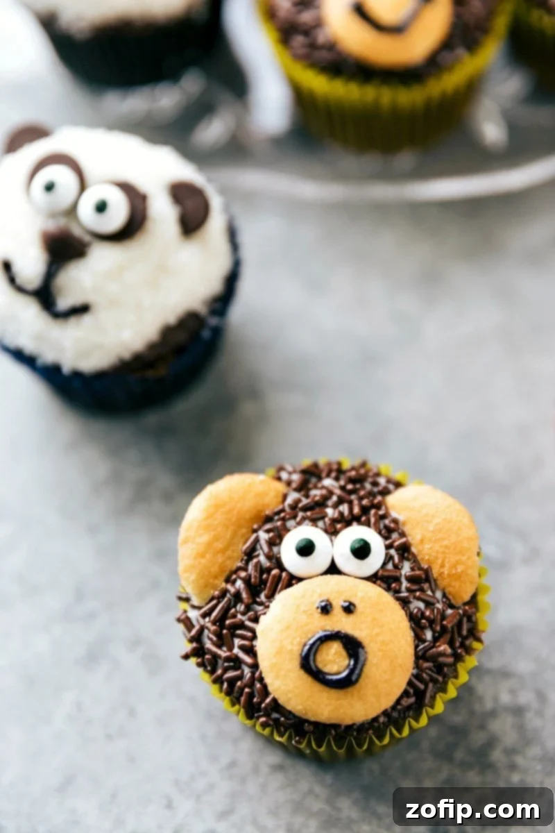 Four simple and easy to make animal jungle cupcakes -- a zebra, monkey, tiger, and a panda. This image showcases the variety of adorable animal-themed treats.