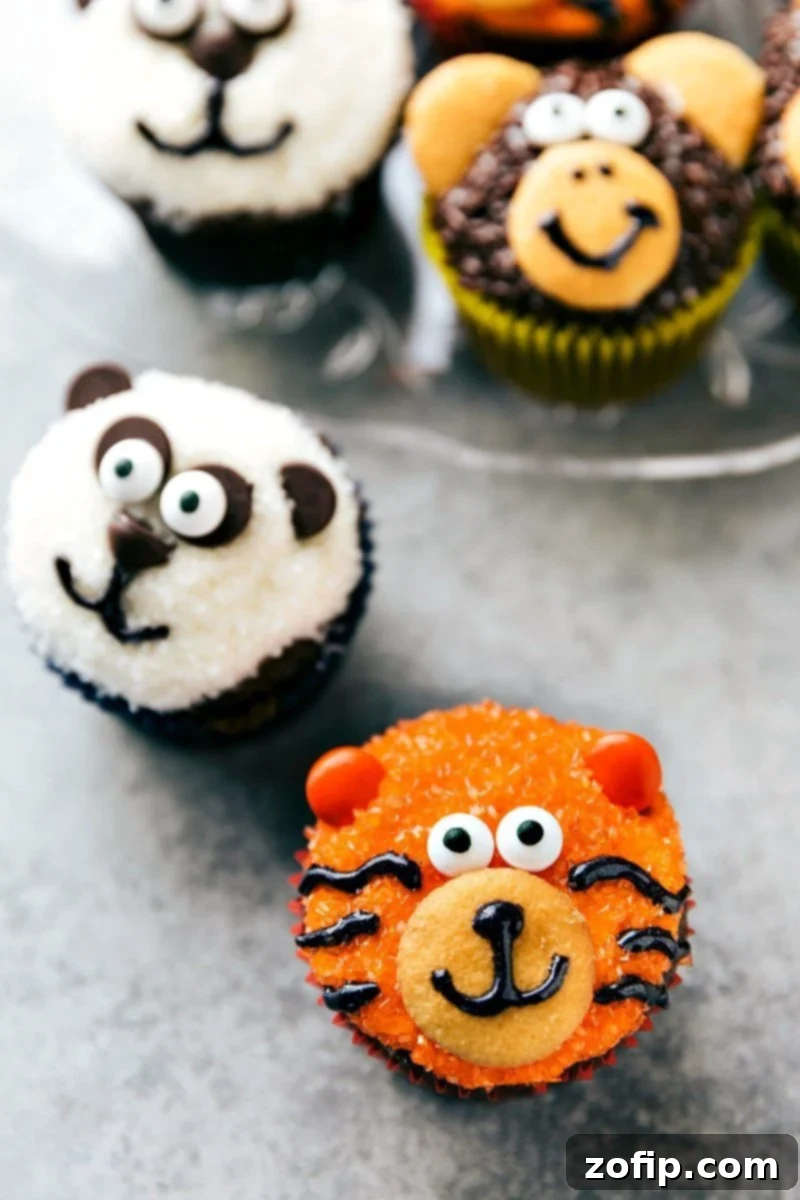 Four simple and easy to make animal jungle cupcakes -- a zebra, monkey, tiger, and a panda. A vibrant collection of themed cupcakes.