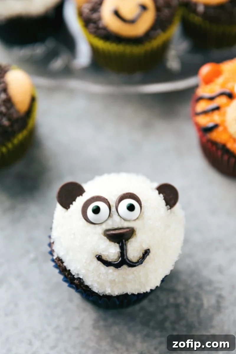 Four simple and easy to make animal jungle cupcakes -- a zebra, monkey, tiger, and a panda. This final image highlights the charming variety of these DIY animal treats.