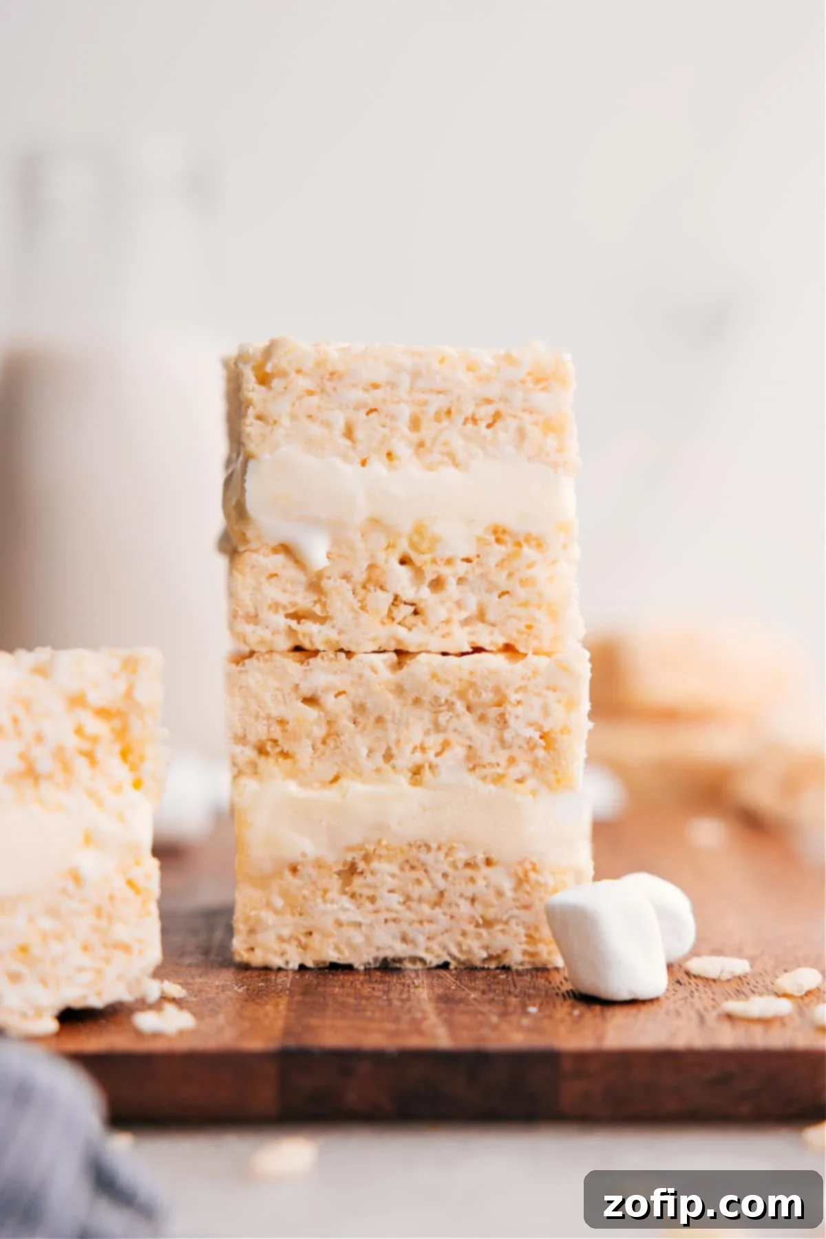 Stacked homemade Rice Krispies Treats Ice Cream Sandwiches, perfectly cut and ready to be enjoyed, showcasing the crispy treat layers and creamy vanilla ice cream filling.