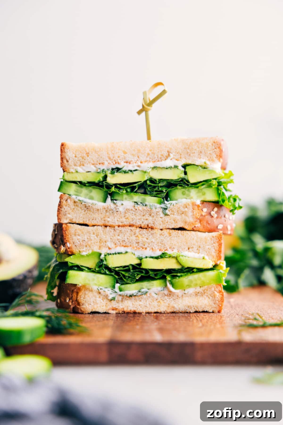 The Best Avocado And Cucumber Sandwich Recipe Avocado sandwich stacked high with fresh ingredients, ready to be enjoyed.
