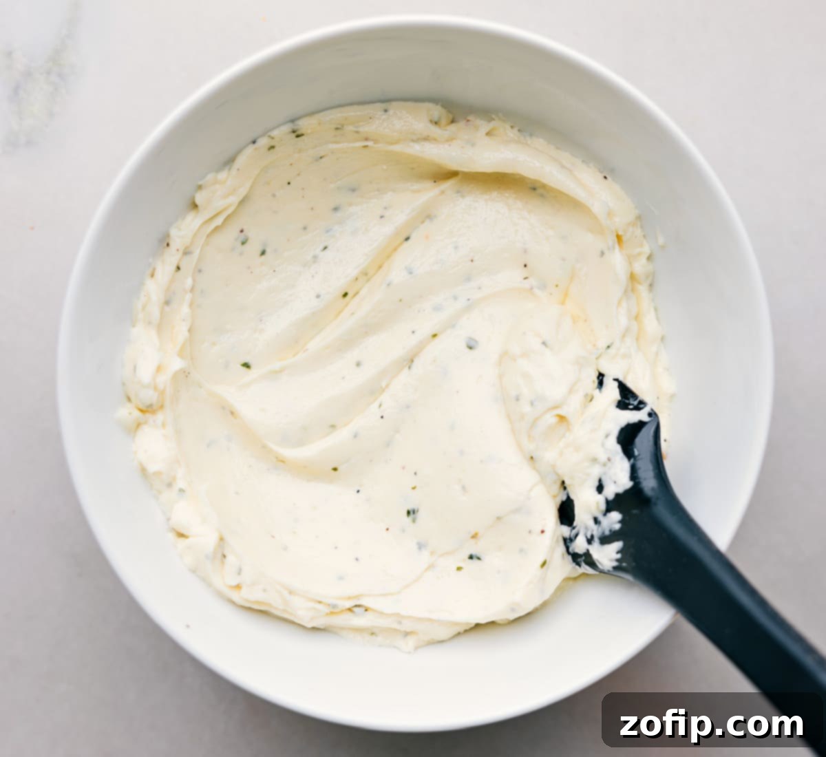 How To Make Avocado Sandwich The creamy herb spread is freshly mixed in a bowl, ready to be generously applied to the avocado sandwich bread.