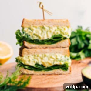 Avocado Egg Salad sandwich on a cutting board.