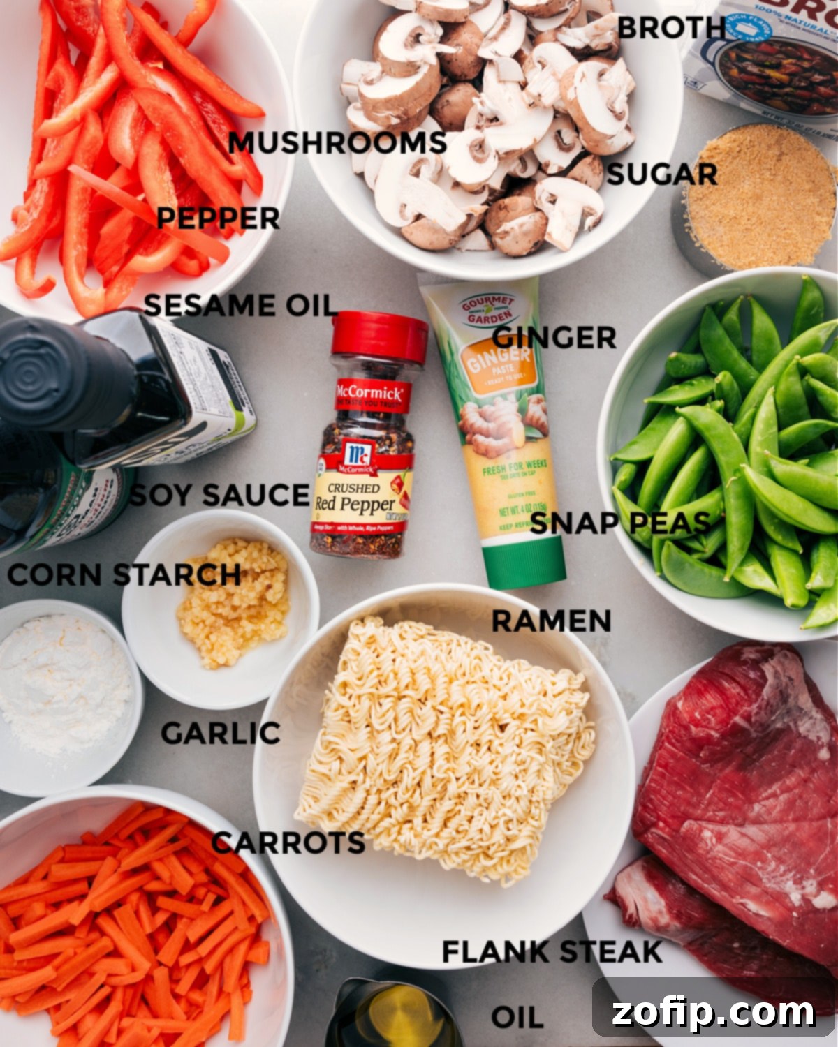 Ingredients In Garlic Beef And Veggie Ramen Recipe All the fresh ingredients for Garlic Beef and Veggie Ramen laid out, including vegetables, broth, noodles, and flank steak.