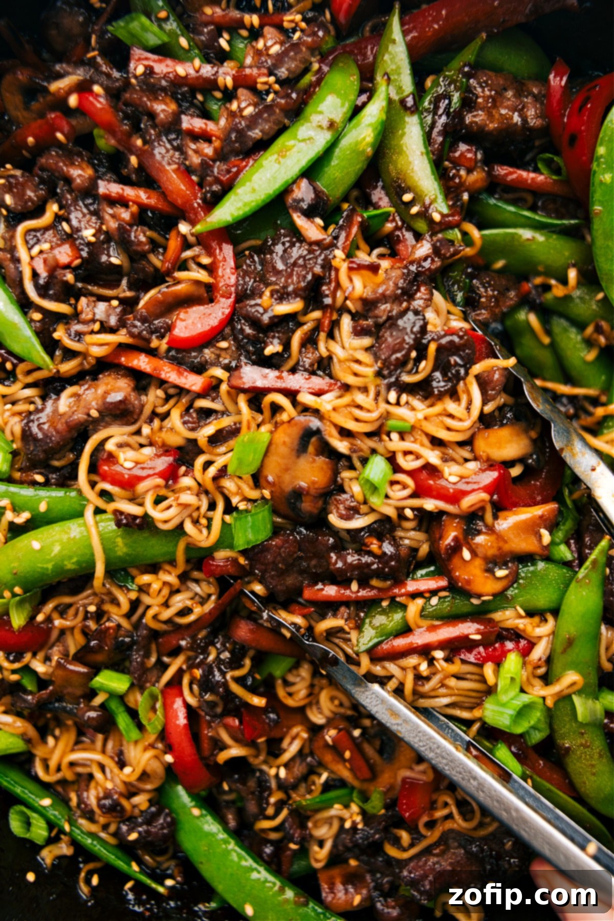 Favorite Garlic Beef And Veggie Ramen Recipe A large bowl of Garlic Beef and Veggie Ramen, tossed together and garnished, ready to be enjoyed.
