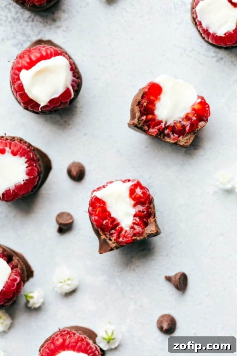 Up-close overhead image of the Chocolate-Covered Raspberries cut in half, showcasing the vibrant raspberry and rich chocolate layers, with an optional cheesecake filling