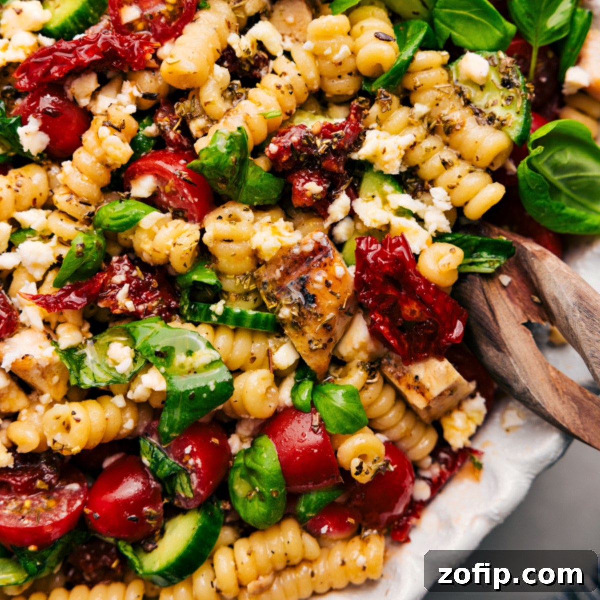 The Perfect Weeknight Dinner Or Side: Marry Me Chicken Pasta Salad The vibrant Marry Me Chicken Pasta Salad served in a large bowl, beautifully tossed with its rich dressing and ready to be served as a delightful weeknight dinner or side dish.