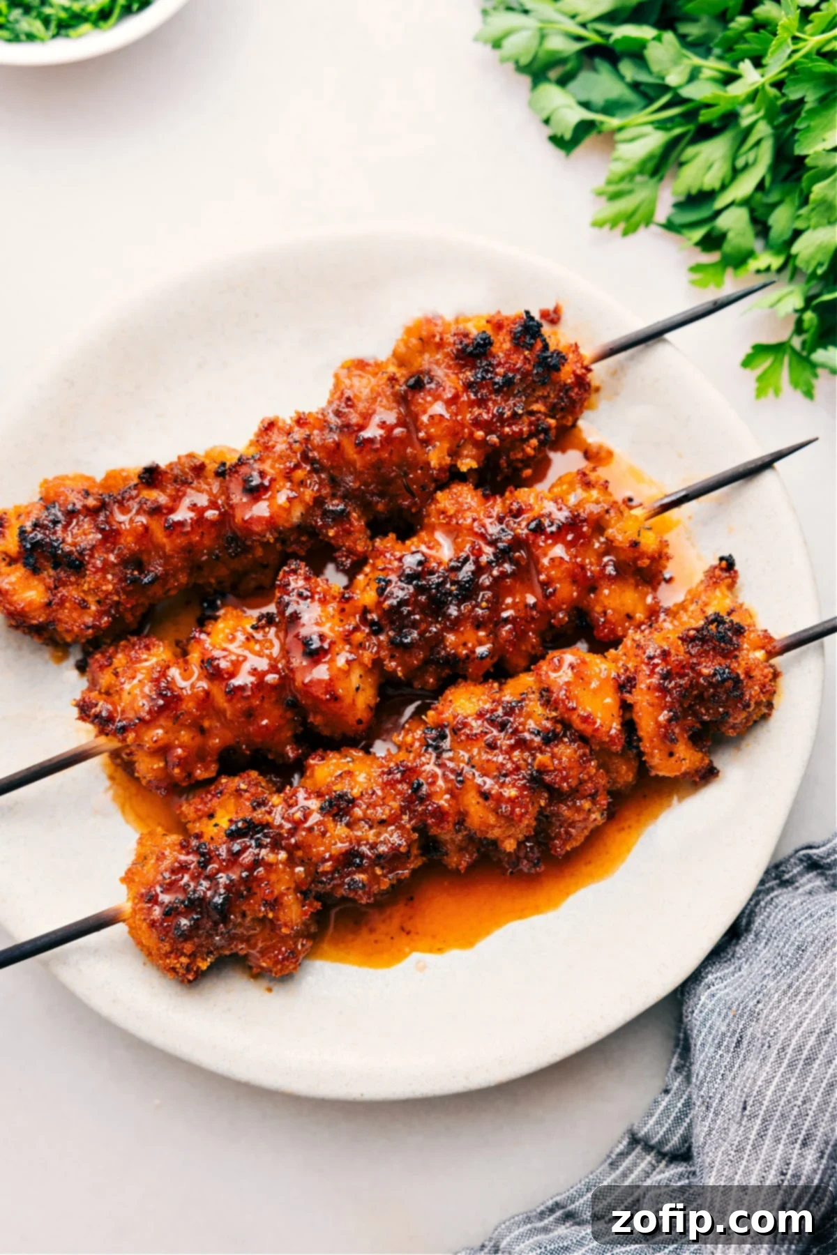 Golden-brown hot honey chicken skewers, glistening with a spicy glaze, fresh out of the oven and ready to be enjoyed.