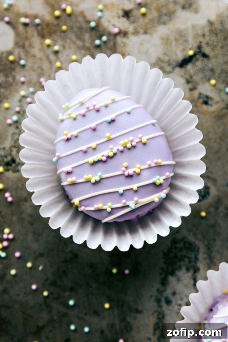 4 Easy Easter Treats 10 A vibrant and enticing collection of all four simple Easter treats: Bunny Bum Cookies, Easter Bunny Cinnamon Rolls, Easter Egg Nests, and Mini Egg Petit Fours, beautifully arranged for a festive display.