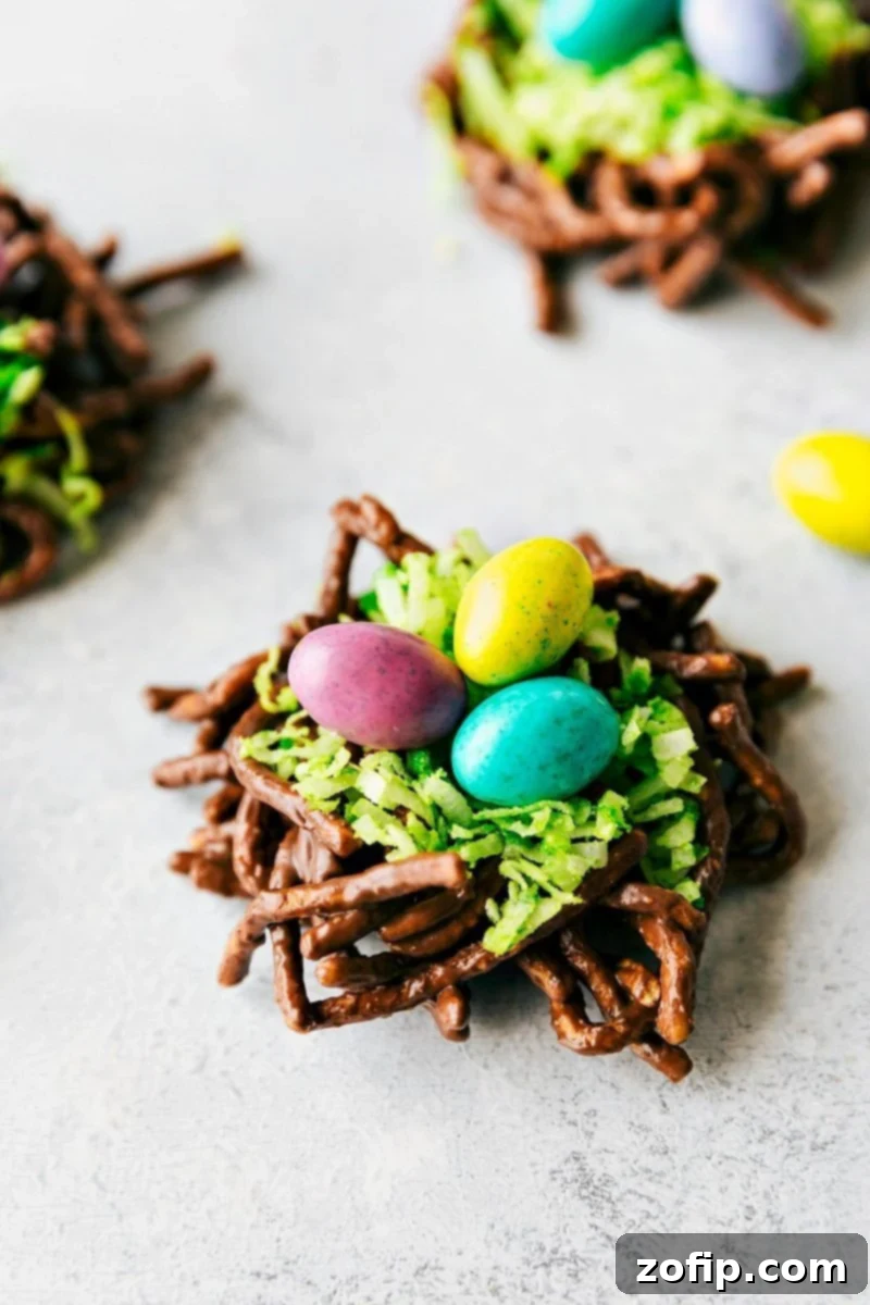4 Easy Easter Treats 6 Crispy chocolate peanut butter nests filled with vibrant green coconut and colorful robin egg M&Ms, a perfect no-bake Easter treat.