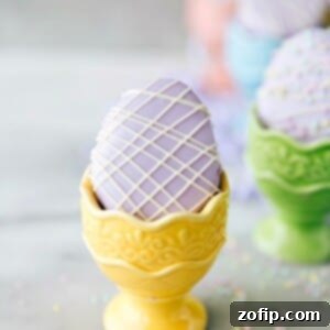 4 Easy Easter Treats 9 Mini 'Egg' Petit Fours, elegantly decorated with smooth frosting and white chocolate drizzle.