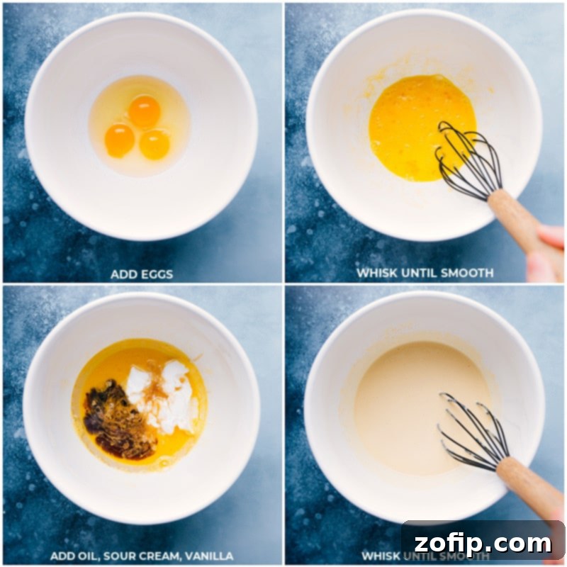 Wet ingredients including eggs, sour cream, oil, and vanilla extract being whisked together in a bowl before dry ingredients are added for cake mix cupcakes.