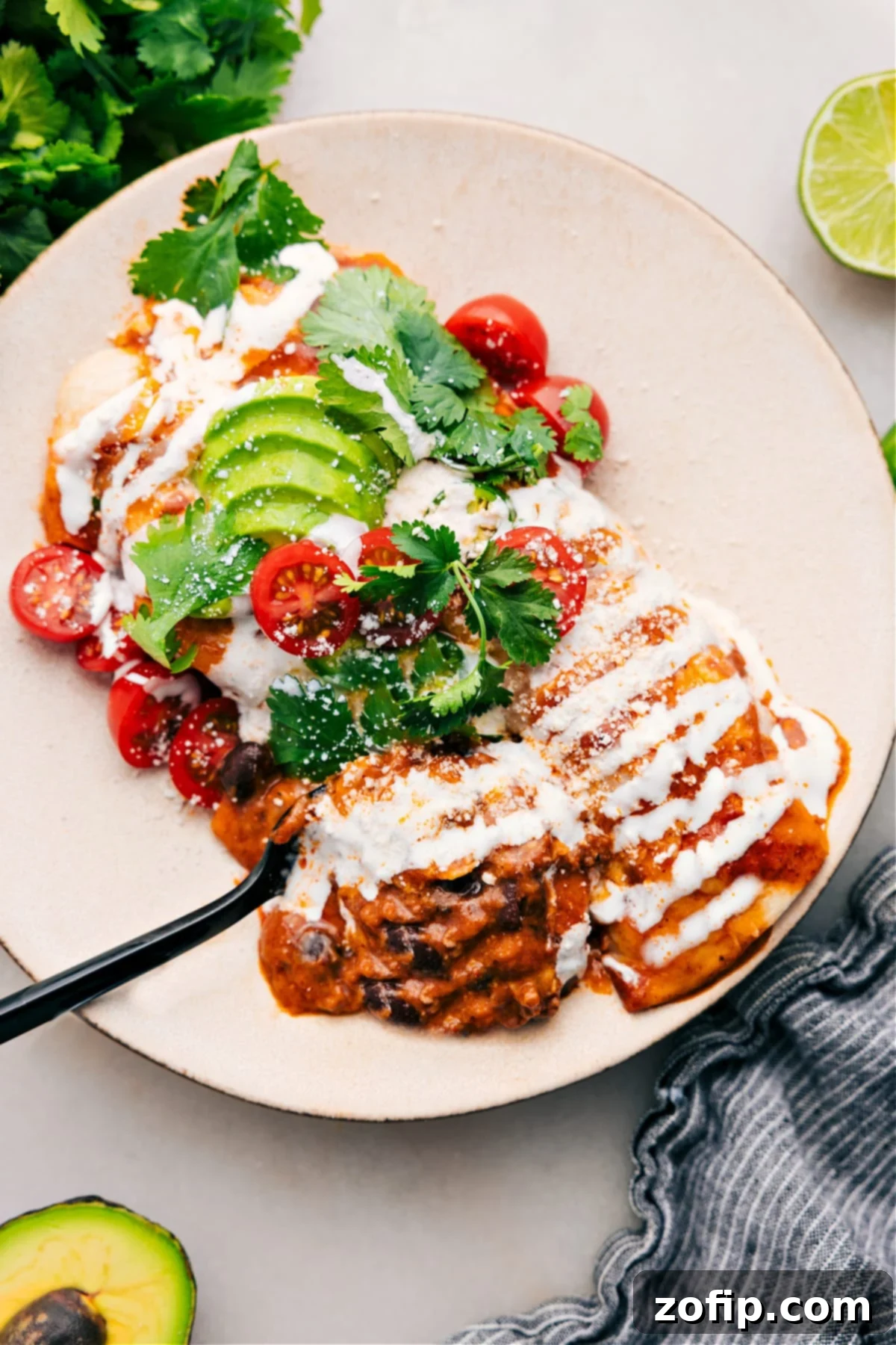 Delicious Ground Beef Enchiladas Recipe A plate of freshly baked Ground Beef Enchiladas, garnished with fresh cilantro, ready to be served.