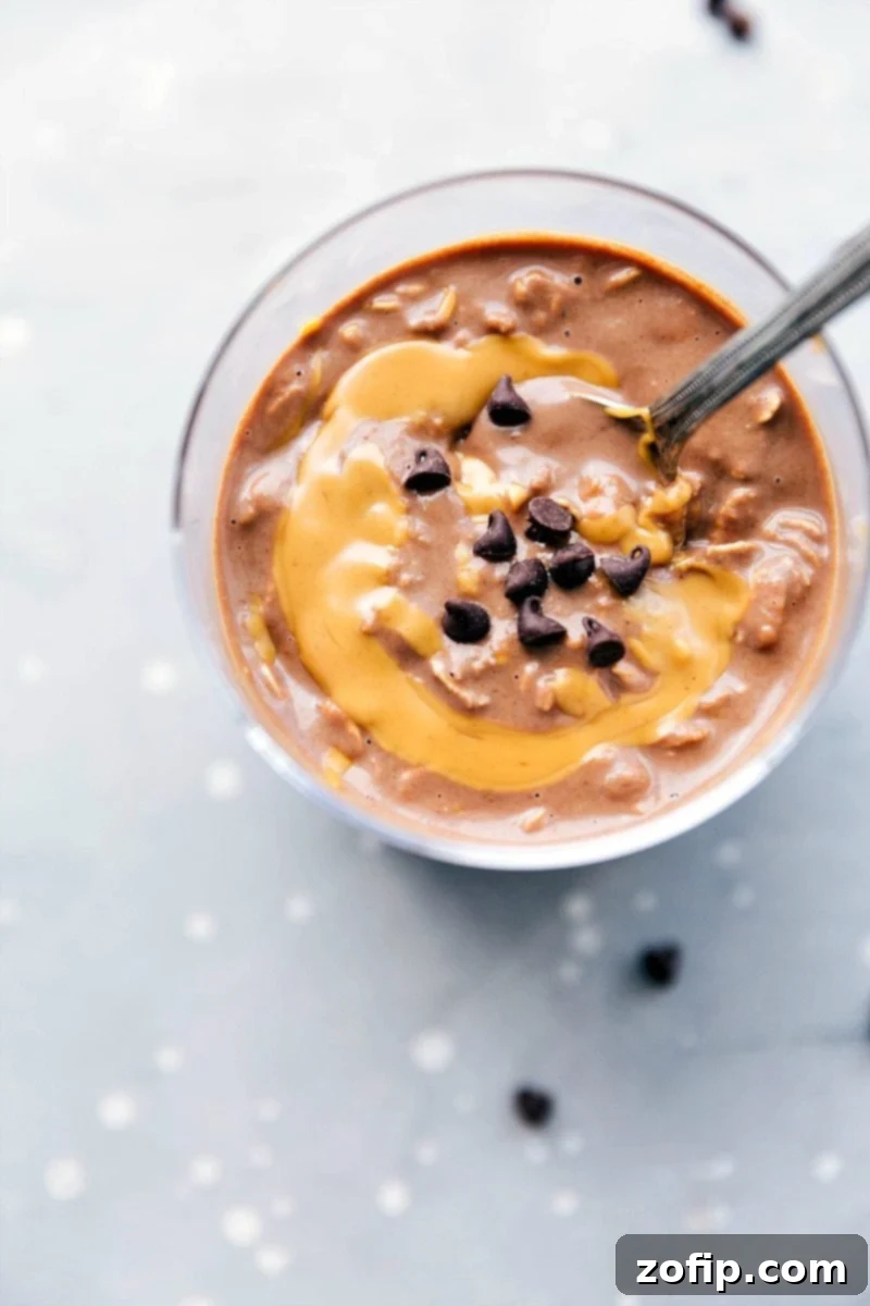 On-the-Go Chocolate Peanut Butter Overnight Oats with Swirl and Chocolate Chips Topping Peanut butter overnight oats, ready to be enjoyed on the go, with a peanut butter swirl mixed in and topped with chocolate chips. A perfect easy breakfast.
