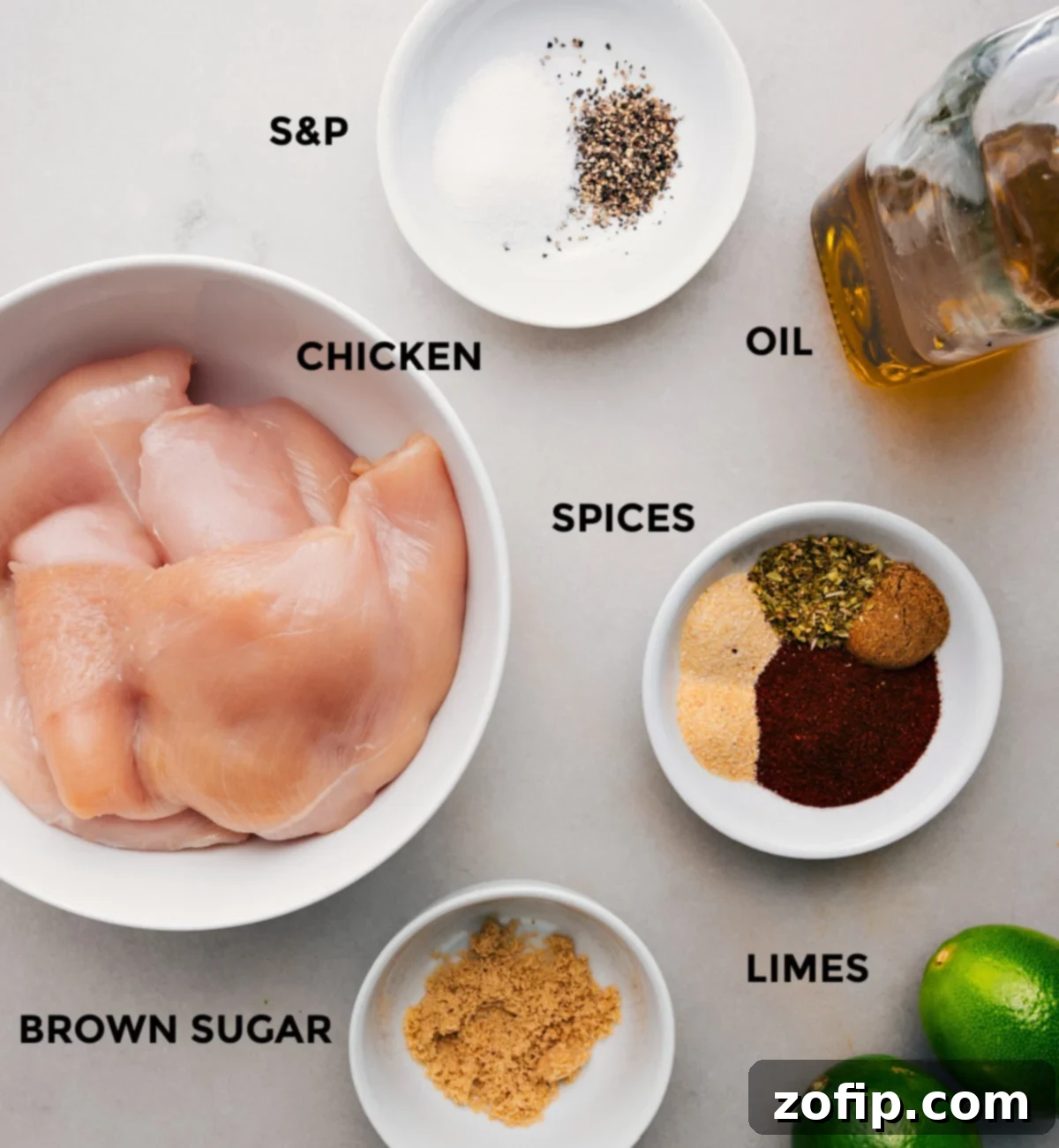 Essential Ingredients for a Zesty Southwest Chicken Dish All the fresh ingredients for Southwest Chicken are prepped and neatly arranged: chicken breasts, a selection of vibrant spices, olive oil, fresh limes, and a small bowl of brown sugar.