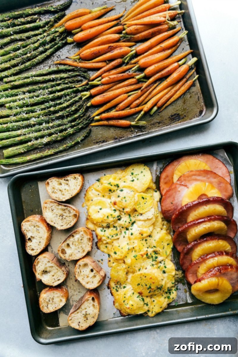 The full Easter menu, including ham, potatoes, carrots, and asparagus, efficiently spread across two sheet pans for easy baking. An overhead shot showcasing all the delicious components of the Easter dinner neatly arranged on two sheet pans, ready for the oven.