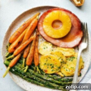 Easter Dinner Done in an Hour 2 A close-up image of the completed one-hour Easter dinner, showcasing ham, potatoes, carrots, and asparagus ready to be served.