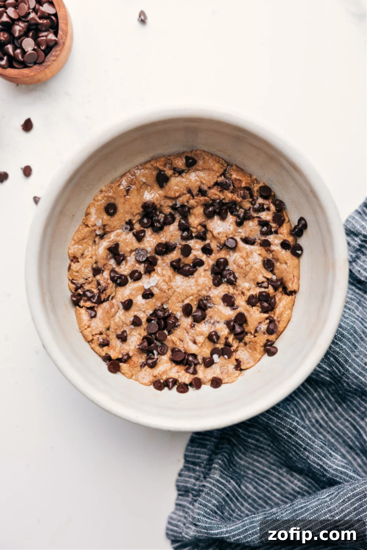 Delicious chocolate chip protein cookie dough in a bowl, ready to be enjoyed.