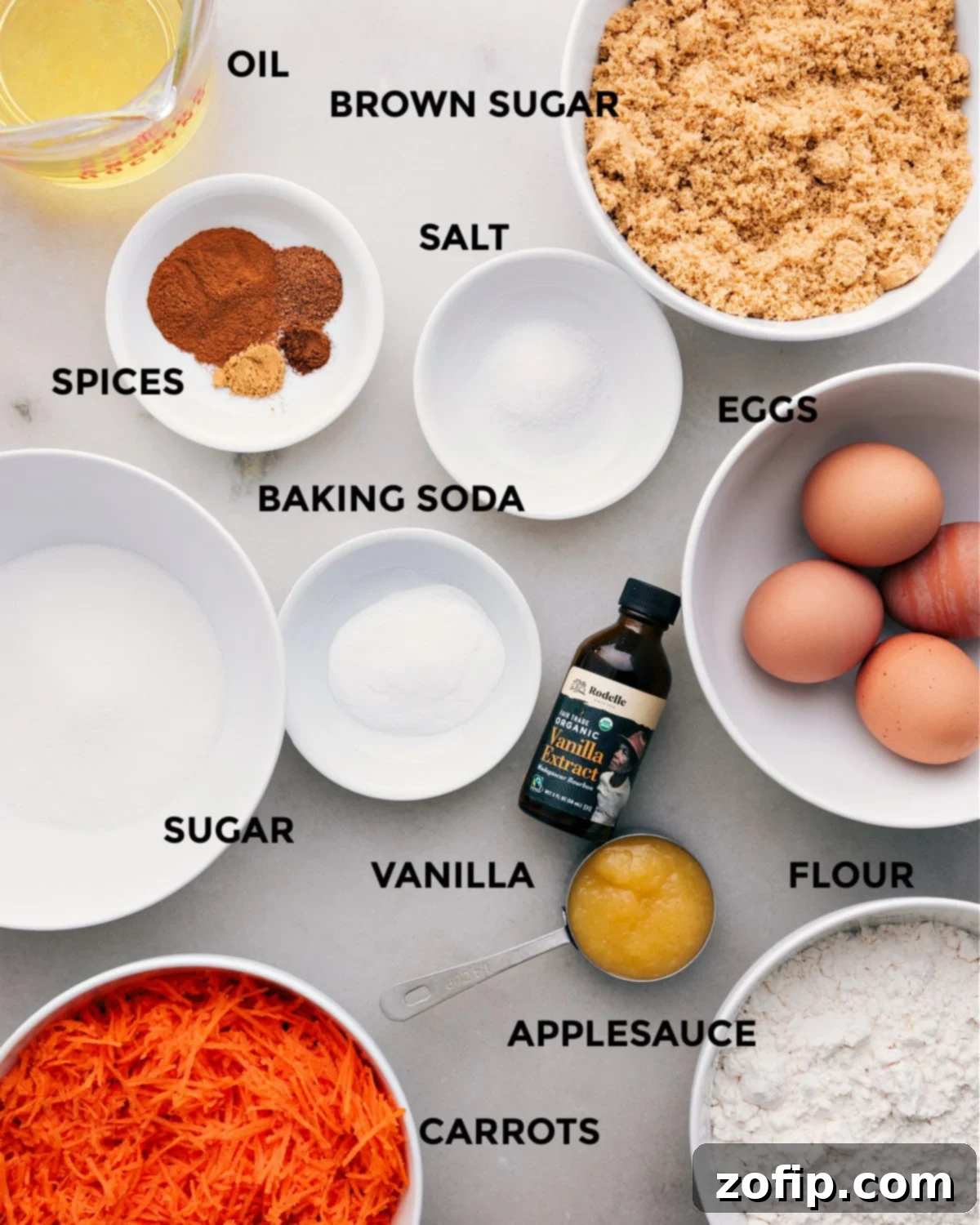 Ingredients In Carrot Cake Recipe All the fresh ingredients for this carrot cake laid out on a kitchen counter: oil, brown sugar, eggs, salt, spices, baking soda, vanilla, granulated sugar, flour, applesauce, and finely grated carrots.