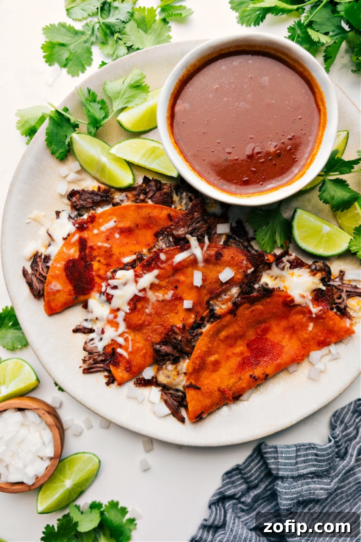 The Best Quesabirria Recipe Quesabirria served with a side of consomé dip.