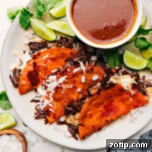 The Ultimate Quesabirria Indulgence 4 A close-up of a finished Quesabirria taco with dipping consomé.