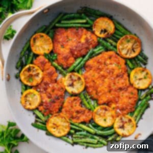 Delicious One-Pan Lemon Parmesan Chicken served with green beans.