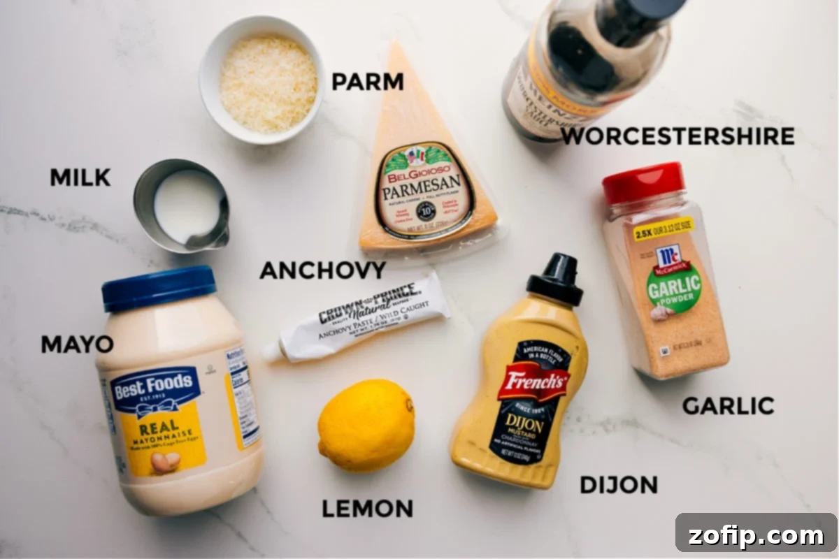 Essential Ingredients For This Homemade Caesar Dressing Recipe A vibrant display of all the essential ingredients for Caesar dressing, meticulously prepped and laid out for easy assembly, including Parmesan cheese, Worcestershire sauce, anchovy paste, fresh lemon, Dijon mustard, minced garlic, milk, and mayonnaise.