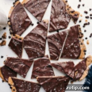Close-up of a piece of Cookie Dough Bark, showing the chocolate topping and edible cookie dough layers.