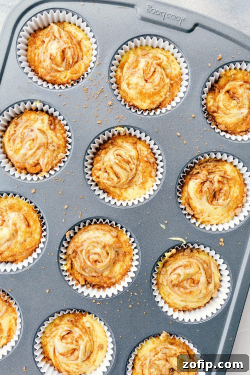 View of a cupcake pan filled with batter and streusel, ready for baking