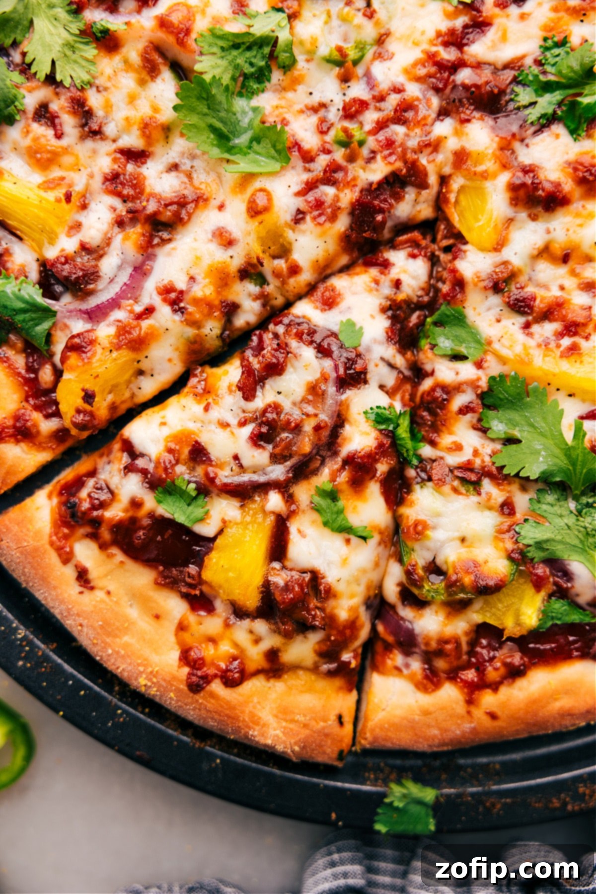 Easy And Delicious BBQ Chicken Pizza Ready To Serve Hot BBQ Chicken Pizza garnished with fresh cilantro, just removed from the oven and perfectly sliced into individual servings, ready to enjoy.