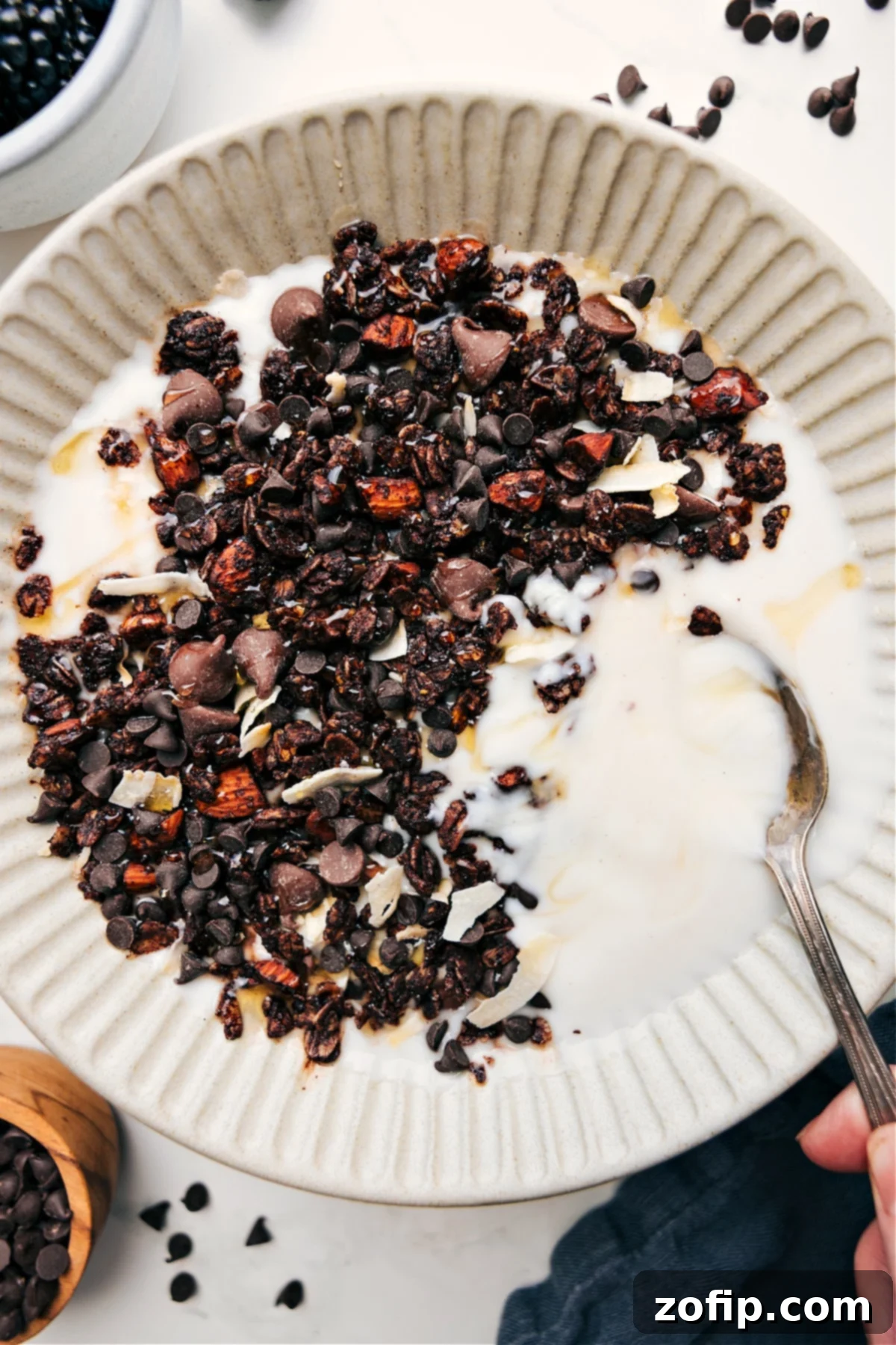 Chocolate Granola Is The Perfect On The Go Snack Decadent chocolate granola served in a yogurt bowl, elegantly drizzled with golden honey, showcasing its rich texture and inviting appearance. Perfect for a wholesome breakfast or a delightful snack.
