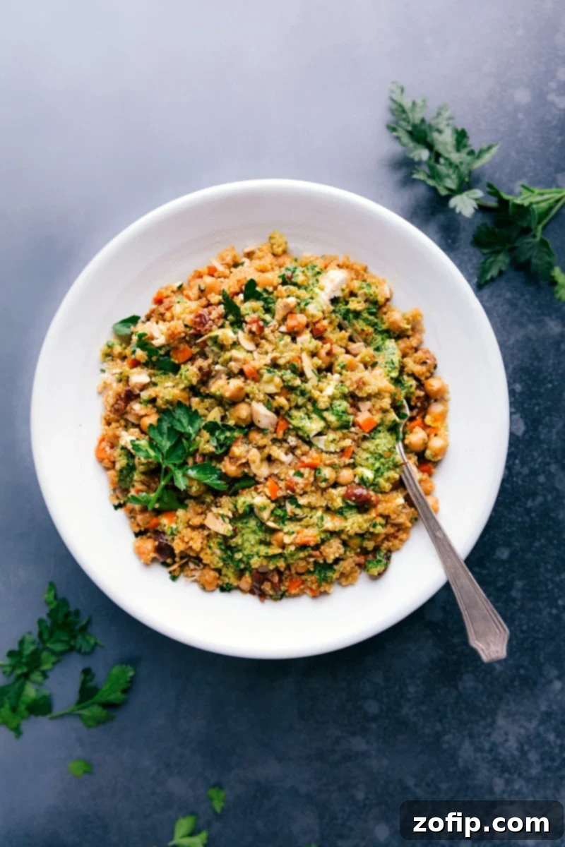 Overhead image of Quinoa Pilaf in a large serving bowl, garnished with fresh herbs.