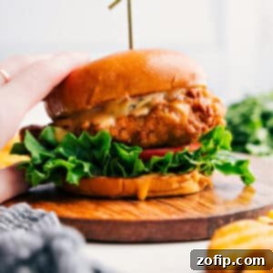 A perfectly golden brown crispy chicken sandwich with lettuce and sauce peaking out.