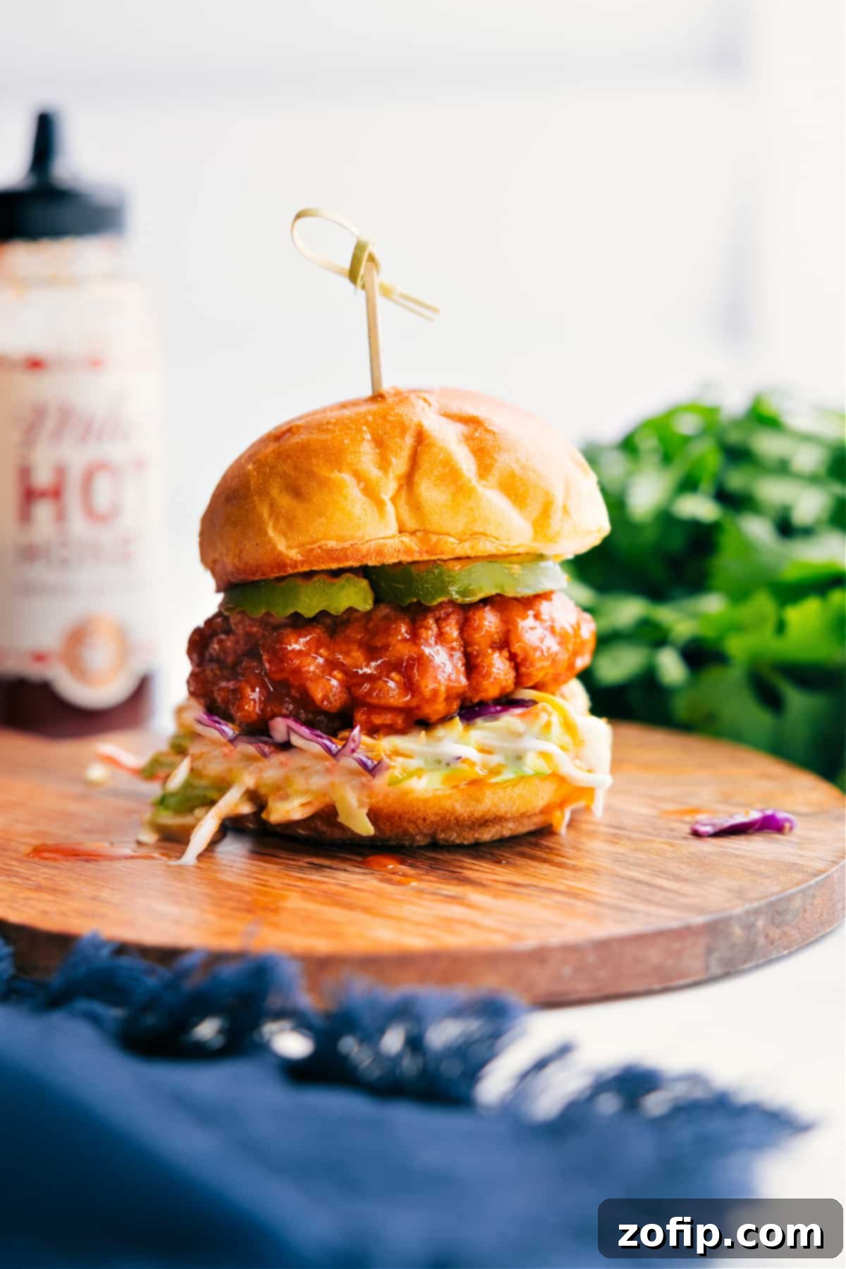 Hot Honey Chicken Sliders layered with creamy coleslaw and tangy pickles on soft slider buns, ready to be devoured.