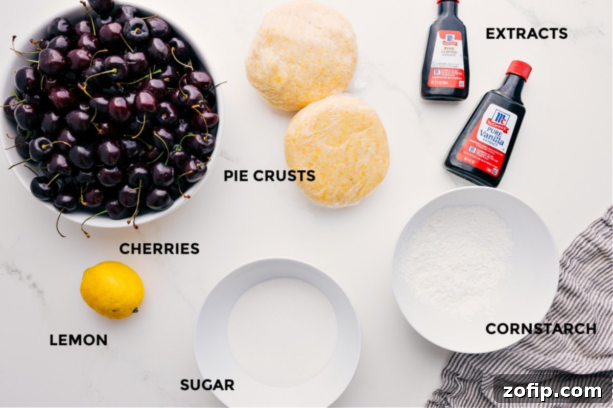 All the prepped ingredients laid out for making the best cherry pie, including fresh cherries, lemon, granulated sugar, cornstarch, butter, vanilla extract, and a homemade pie crust.