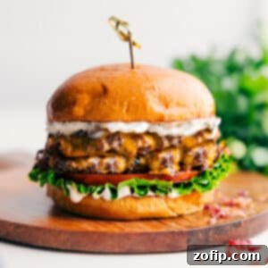 Appetizing Crack Burger with melted cheese, bacon, and a generous amount of sauce.