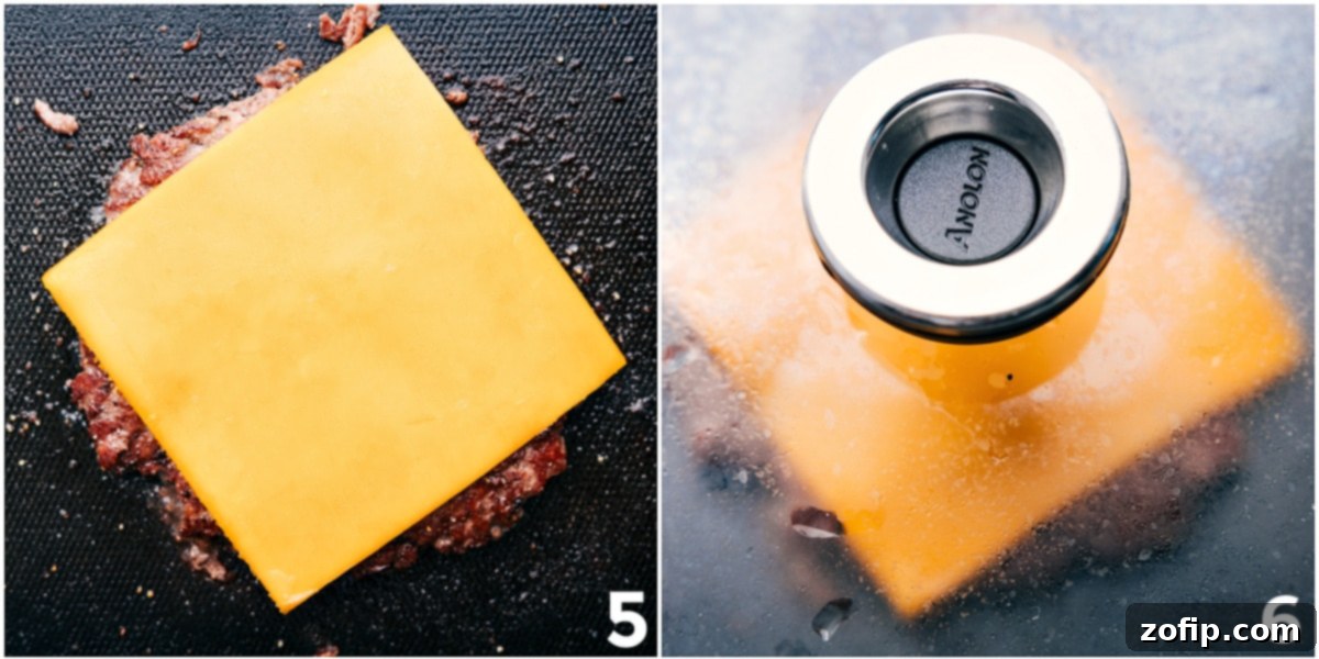 A delicious smashburger with a slice of sharp cheddar cheese melting perfectly onto the hot, crispy patty, promising a gooey, flavorful bite.