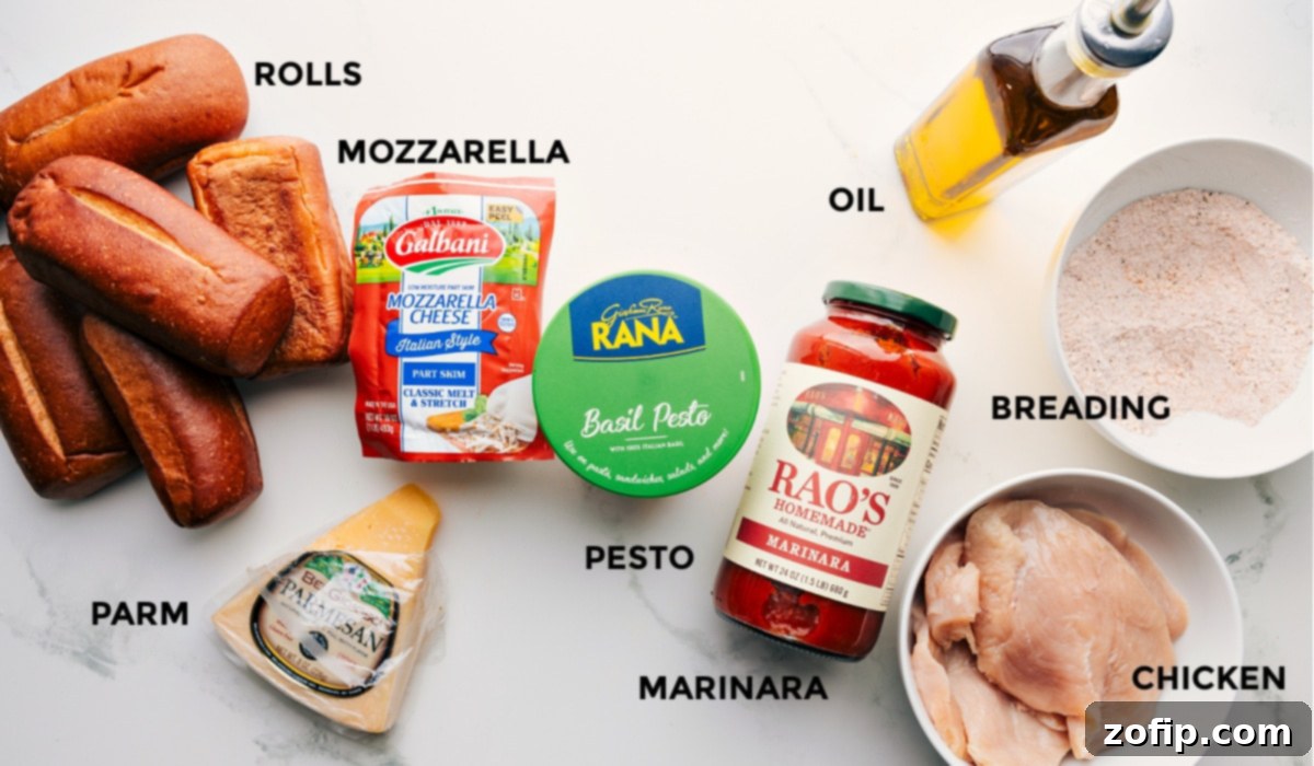 Ingredients In Chicken Parmesan Sandwich All the ingredients prepped and ready for easy assembly: rolls, mozzarella, parmesan, pesto, marinara, breading, oil, and chicken.