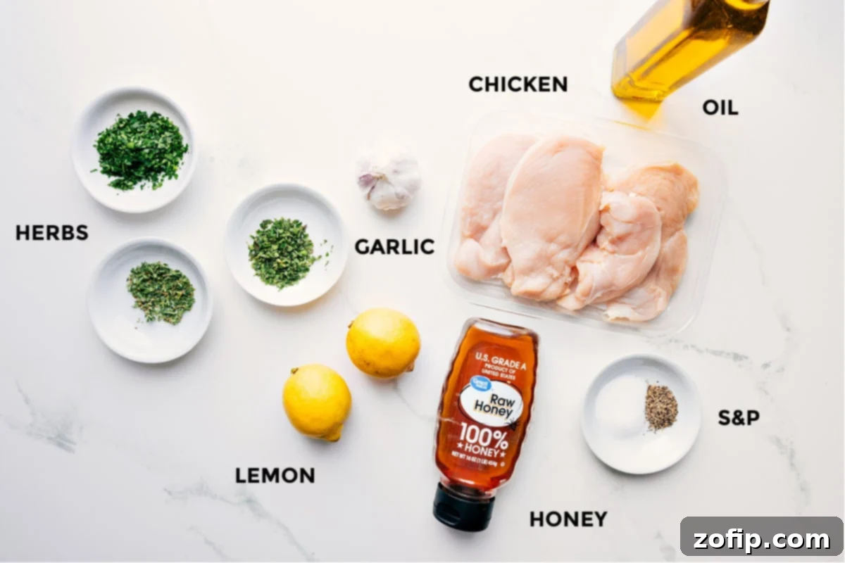 All the ingredients for Greek Chicken Marinade prepped out for easy assembly including fresh herbs, vibrant lemon, minced garlic, raw chicken, golden honey, and rich olive oil.