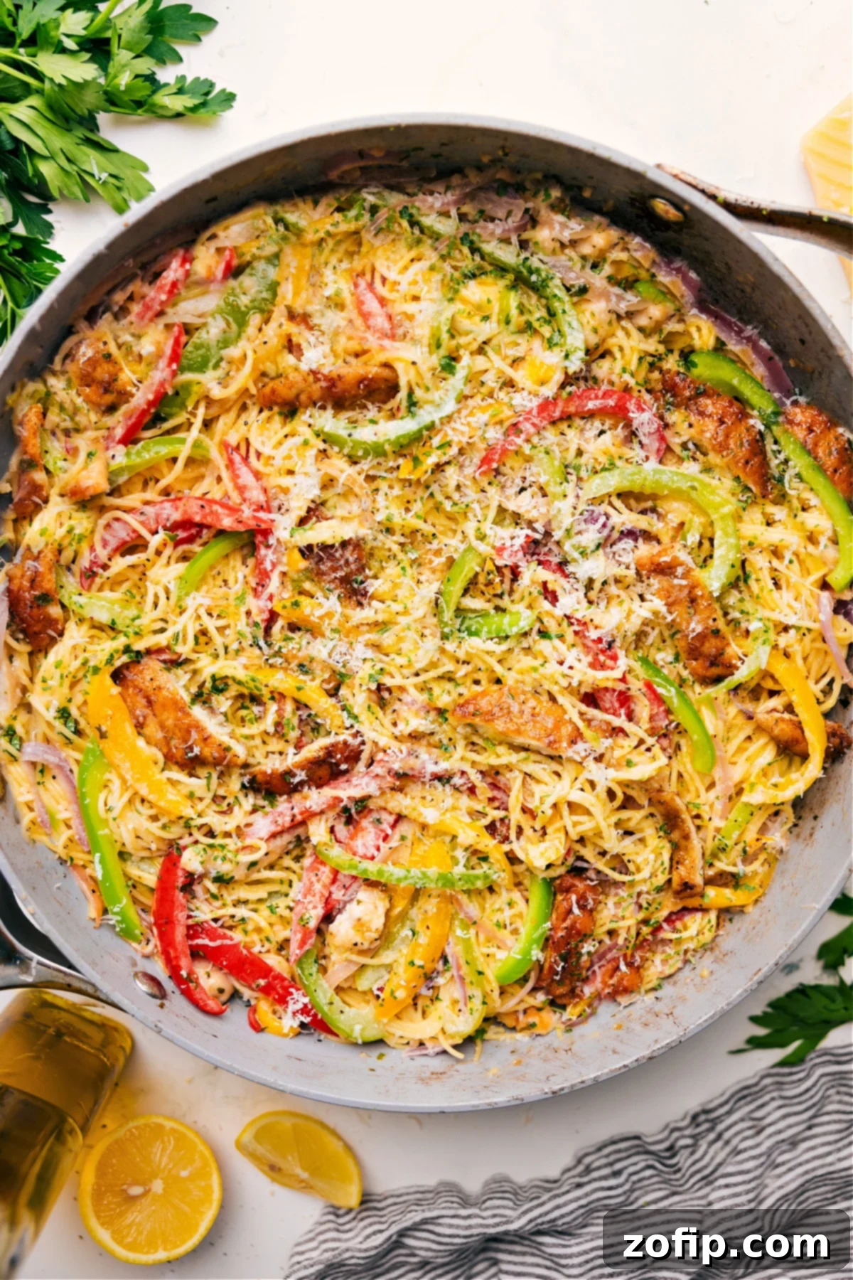 One Skillet Chicken Scampi Recipe Chicken Scampi in a skillet topped with freshly grated cheese, ready to serve.